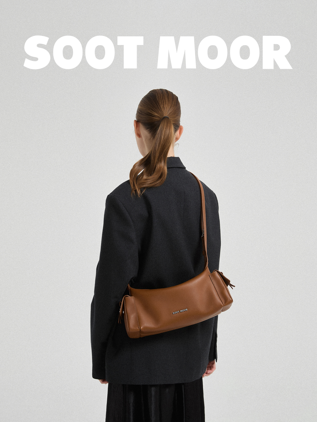 SOOT MOOR brown leather shoulder bag styled with a black jacket